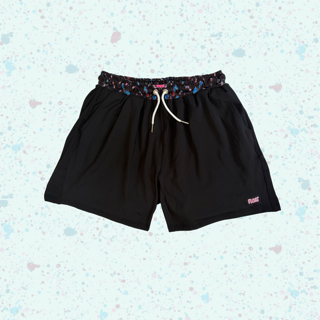 Black shorts with a colorful waistband on a light blue background