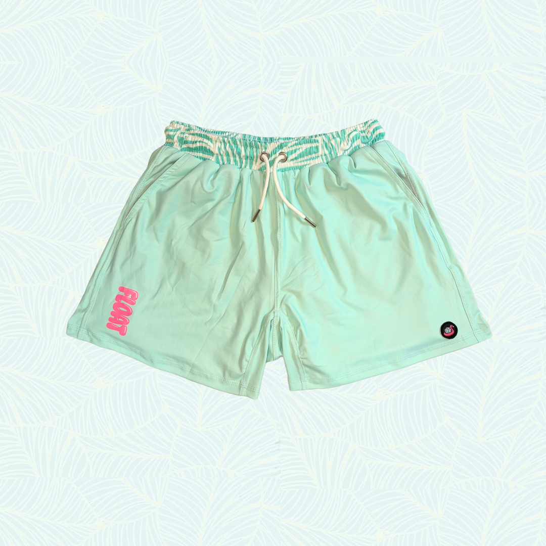 Light green shorts with a small pink logo on a light blue background