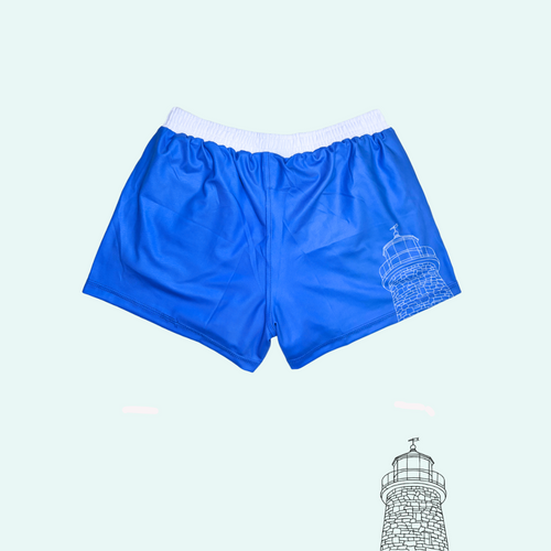 Blue shorts with a white elastic waistband and a small white line-art lighthouse graphic on the lower right leg, shown on a pale mint background.