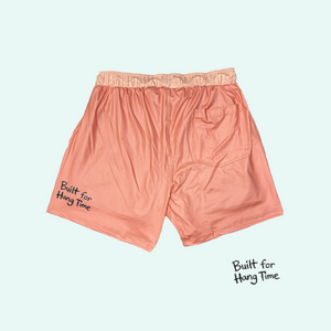 Pink boxer briefs with text on a light blue background