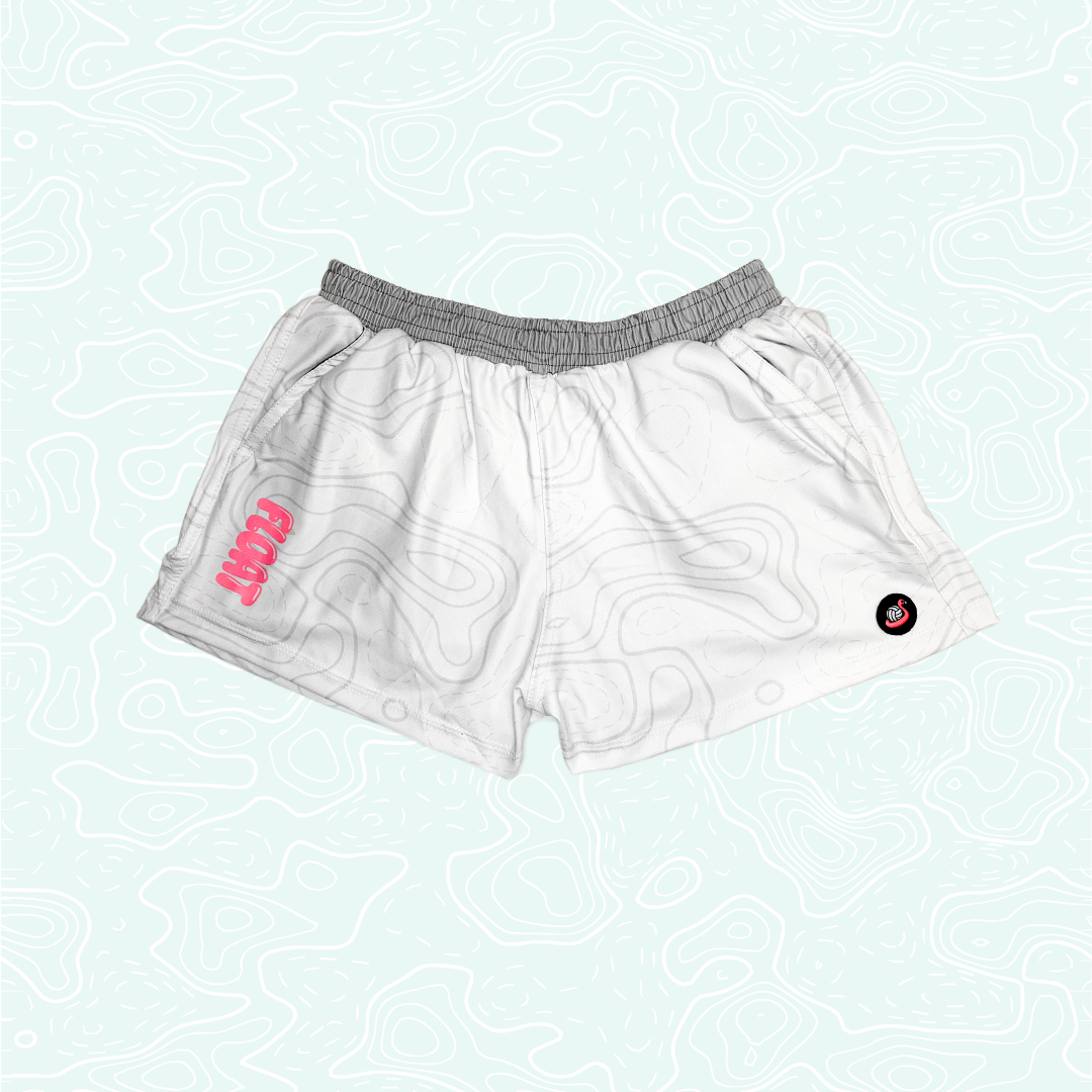 White athletic shorts with a gray elastic waistband, featuring a pink FLOAT logo on the left side and a small black circular logo on the right side, displayed against a pale mint green background.